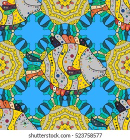 Seamless pattern of bright colorful doodles fishes on blue. Vector.