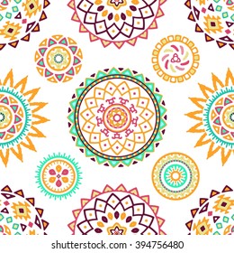Seamless pattern of bright colorful geometric round ethnic decorative elements. Vector mandala background with bohemian, Oriental, Indian, Arabic, Aztec motifs.