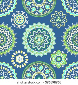 Seamless pattern of bright colorful geometric round ethnic decorative elements. Vector mandala background with bohemian, Oriental, Indian, Arabic, Aztec motifs.