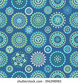 Seamless pattern of bright colorful geometric round ethnic decorative elements. Vector mandala background with bohemian, Oriental, Indian, Arabic, Aztec motifs.