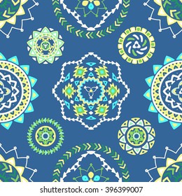 Seamless pattern of bright colorful geometric round ethnic decorative elements. Vector mandala background with bohemian, Oriental, Indian, Arabic, Aztec motifs.
