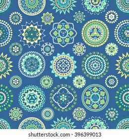 Seamless pattern of bright colorful geometric round ethnic decorative elements. Vector mandala background with bohemian, Oriental, Indian, Arabic, Aztec motifs.