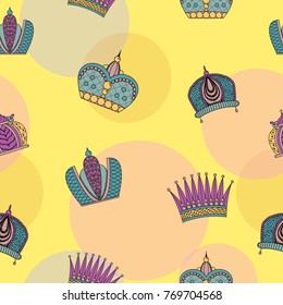 Seamless pattern with bright graceful crowns on a yellow background.