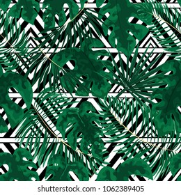 seamless pattern of bright green tropical leaves on grey background. Tropical palm leaves, jungle leaves seamless vector floral pattern background.