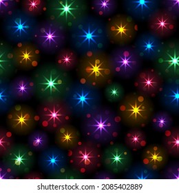 Seamless pattern from bright shining colored stars and circles over black background festive design and decorating