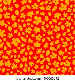 Seamless pattern of brown autumn leaves on red background