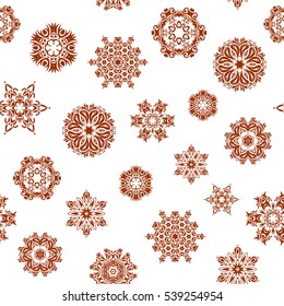 Seamless pattern of brown snowflakes and dots on white background. Vector abstract design in brown colors.