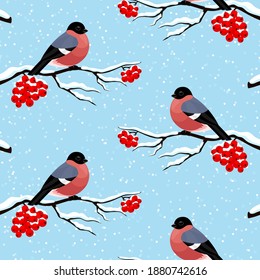 Seamless pattern with bullfinches on rowan branches on a blue background.