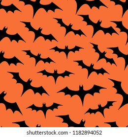 Seamless pattern with a bunch of bats on orange background, Halloween themes
