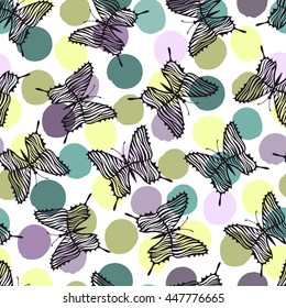 Seamless pattern with butterflies on a polka dot background.