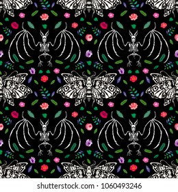 Seamless pattern. Butterflies and skeletons of bats among flowers. Isolated on a black background. Great for tattoo or print on a T-shirt. Ideal for decoration of Halloween and the Day of the Dead.