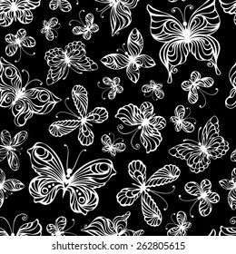 Seamless pattern of butterflies. Various ornate white butterflies on black background. 