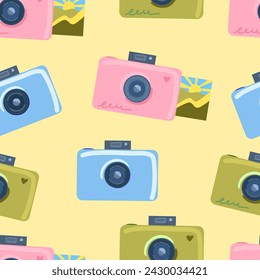 seamless pattern with cameras. in delicate colors on a light yellow background. photography concept, print