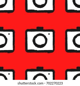 Seamless pattern with cameras. Painted by hand with rough brush. Grunge, sketch, ink, graffiti, watercolour. Vector illustration. Black, red, white colour.