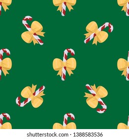 Seamless pattern of candy canes on green background. Christmas vector backdrop