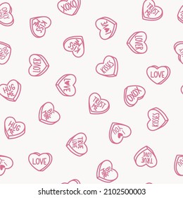 Seamless Pattern with Candy Hearts on a pink background. Candy in form of hearts with messages. Conversation Hearts. Hand-drawn illustration for  Valentines Day. Drawing, line art, ink, vector.