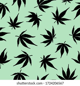 Seamless pattern of cannabis leaves on a green background. Black hemp leaves on a green background. Vector illustration