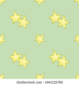 Seamless pattern with carambola. Yellow stars on a gentle green background. Wallpaper, packaging, print, modern design textiles. Vector illustration.