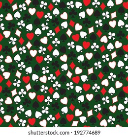Seamless pattern of card symbols arranged randomly on the green.Vector.