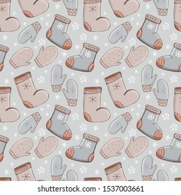 Seamless pattern of cartoon vector winter accessories. Hand drawing of winter, warm clothes - mittens, shoes. Fashion graphic. Bundle of seasonal clothing. Winter background. Doodle