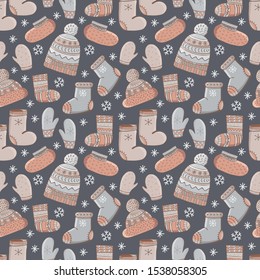 Seamless pattern cartoon vector winter accessories. Hand drawing of winter, warm clothes. Socks, a cap with a pompom, mittens, valenki, shoes. Fashion graphic.Seasonal clothing. Winter background