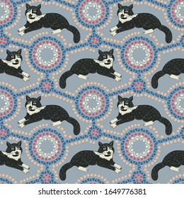 Seamless pattern of cat with ethnic ornament elements. Repeatable textile vector print 