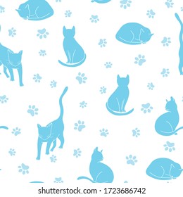 Seamless pattern with cat silhouettes and paws in light blue