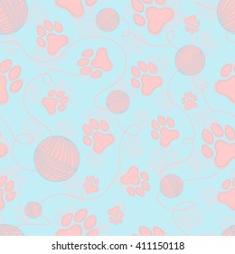 Seamless pattern with cats paws, ball of yarn and threads. 