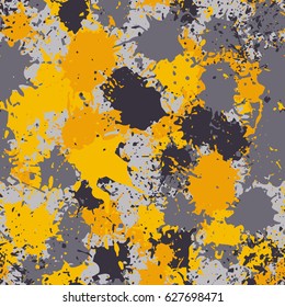 Seamless pattern. The chaos of spots and splashes. Fashionable camouflage. Yellow, gray, gray-brown.