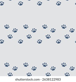 Seamless pattern of charming dark blue paw prints scattered on a light gray background. Neutral colors, perfect for minimalist pet-themed designs and modern decor.