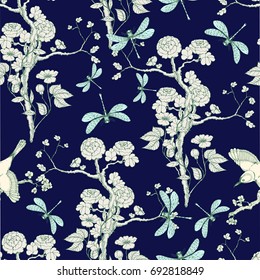 Seamless pattern in the chinoiserie style with peonies, dragonfly and bird on deep blue background for wedding, scrapbooking, wallpaper and other design.