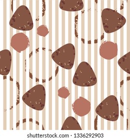 Seamless pattern with chocolate candiesand cup stains at striped background.