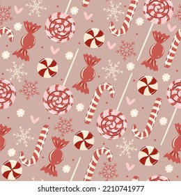 Seamless pattern with Christmas candies and snowflakes. Vector graphics.