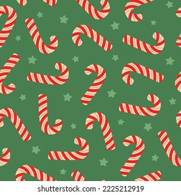 Seamless pattern of Christmas candy cane and stars on green background. Festive background for wrapping paper, invitation, greeting card, textile. Vector illustration