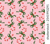 Seamless pattern with Christmas candy canes and bows on pink background. Cute background design for fabric, wrapping paper, textile, wallpaper