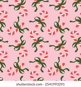 Seamless pattern with Christmas candy canes and bows on pink background. Cute background design for fabric, wrapping paper, textile, wallpaper