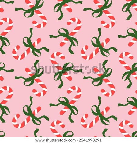 Seamless pattern with Christmas candy canes and bows on pink background. Cute background design for fabric, wrapping paper, textile, wallpaper