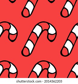 Seamless pattern with christmas caramel cane. Doodle vector illustration with caramel cane icons on red background. Vintage caramel cane, sweet elements background for your project.