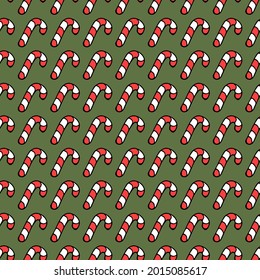 Seamless pattern with christmas caramel cane. Doodle vector illustration with caramel cane icons on green background. Vintage caramel cane, sweet elements background for your project.