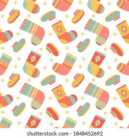 Seamless pattern christmas colorful warm knitted socks and winter shoes. Background from winter woolen clothing with Norwegian ornaments. Trendy clothing items. Modern garment. Vector illustration