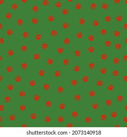 Seamless pattern with Christmas decoration. Red paws on green background.