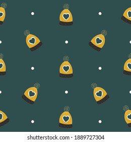 Seamless pattern with christmas hats on green background