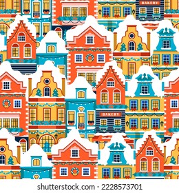 Seamless pattern with Christmas houses. Bright European vintage facades with snow, decor and garlands