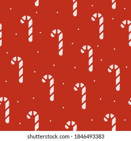 Seamless pattern of Christmas lollipop in flat style on a red background.