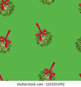 Seamless pattern of Christmas mistletoe bushes on a green background