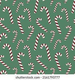 Seamless pattern for Christmas and New Year. Hand-drawn vector illustration of candy canes on a green background.