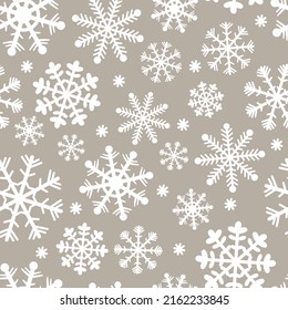 Seamless pattern for Christmas and New Year. Hand-drawn vector illustration of snowflakes in white on a beige background.
