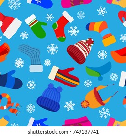 Seamless pattern of Christmas warm winter clothes in flat style on light blue background