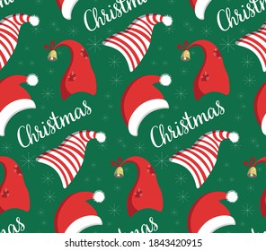 Seamless pattern of Christmas, winter hats - striped, red, with a bell.Christmas collection of caps on a green background.