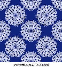 Seamless pattern, a circular pattern. A flock of fish and circles. Blue and white graphics, mandala of fish. For the design and decoration background, wallpaper, packaging, fabrics, textiles.